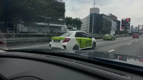 Amaron branded car advertising campaign driving on a Malaysian highway